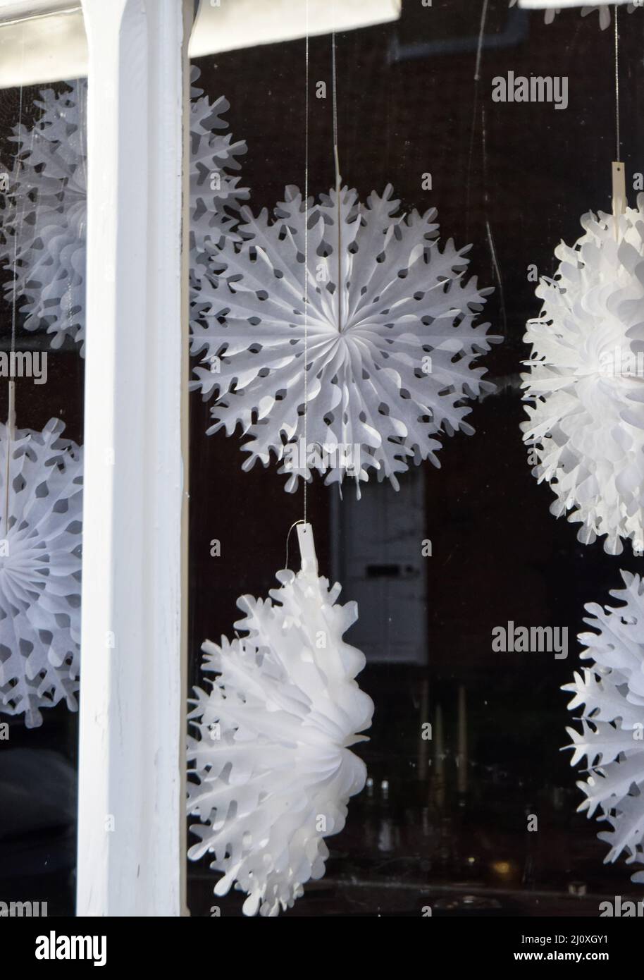 paper snowflake decorations in window, england Stock Photo