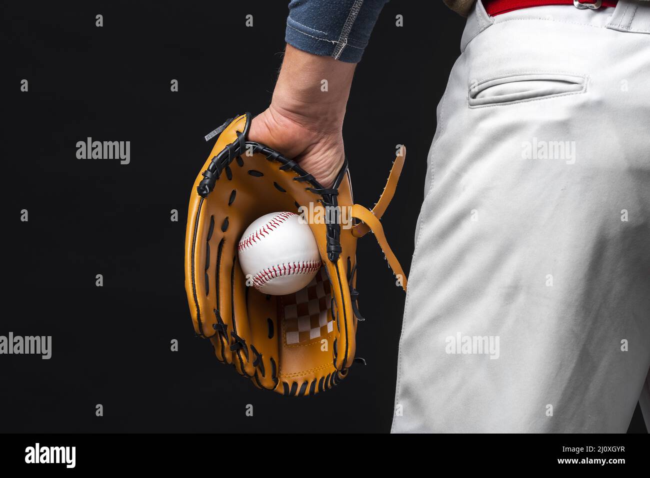 Back view man holding glove with baseball. High quality beautiful photo concept Stock Photo