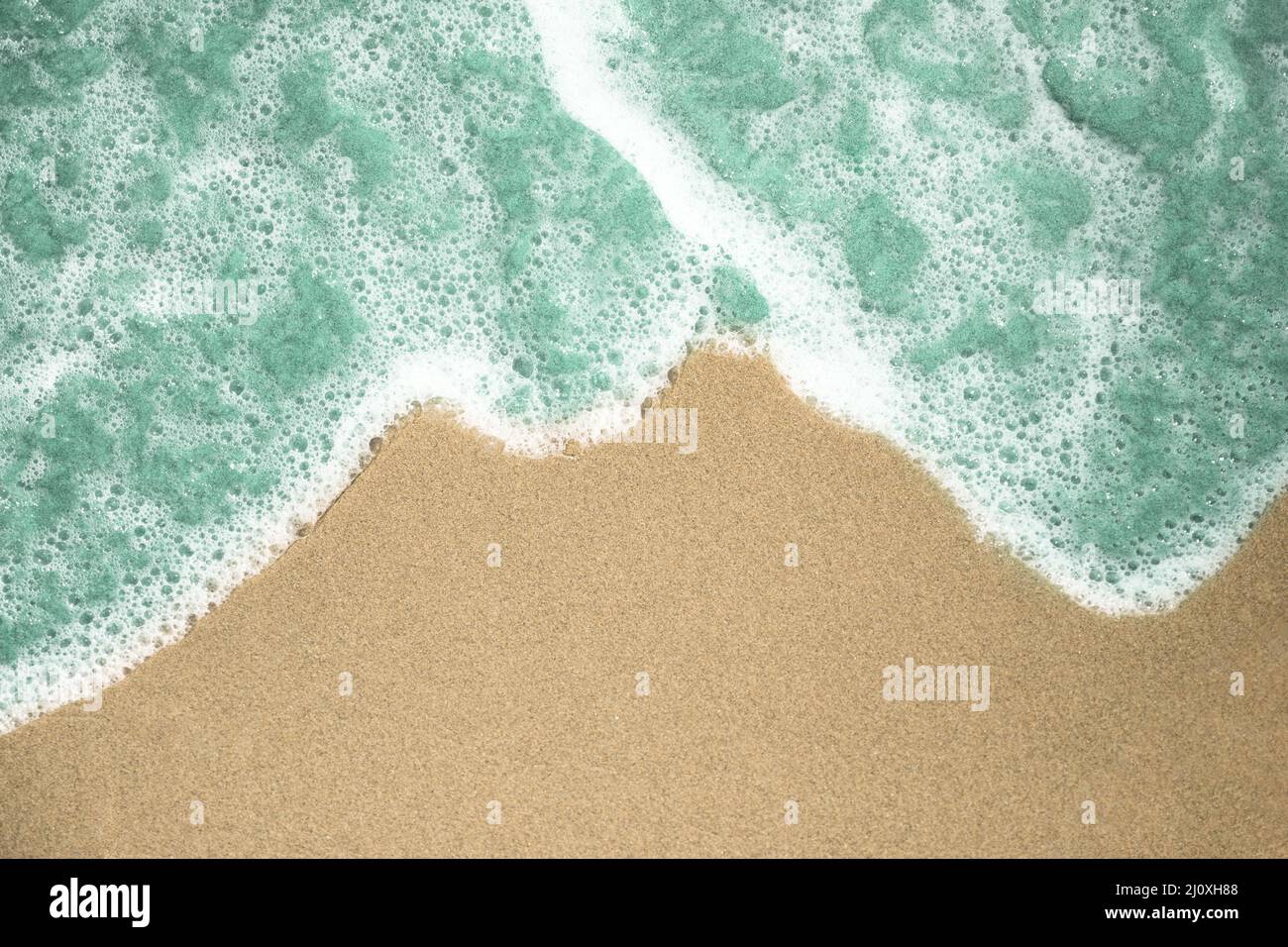 Close up top view bubbly water tropical sandy beach. High quality photo Stock Photo