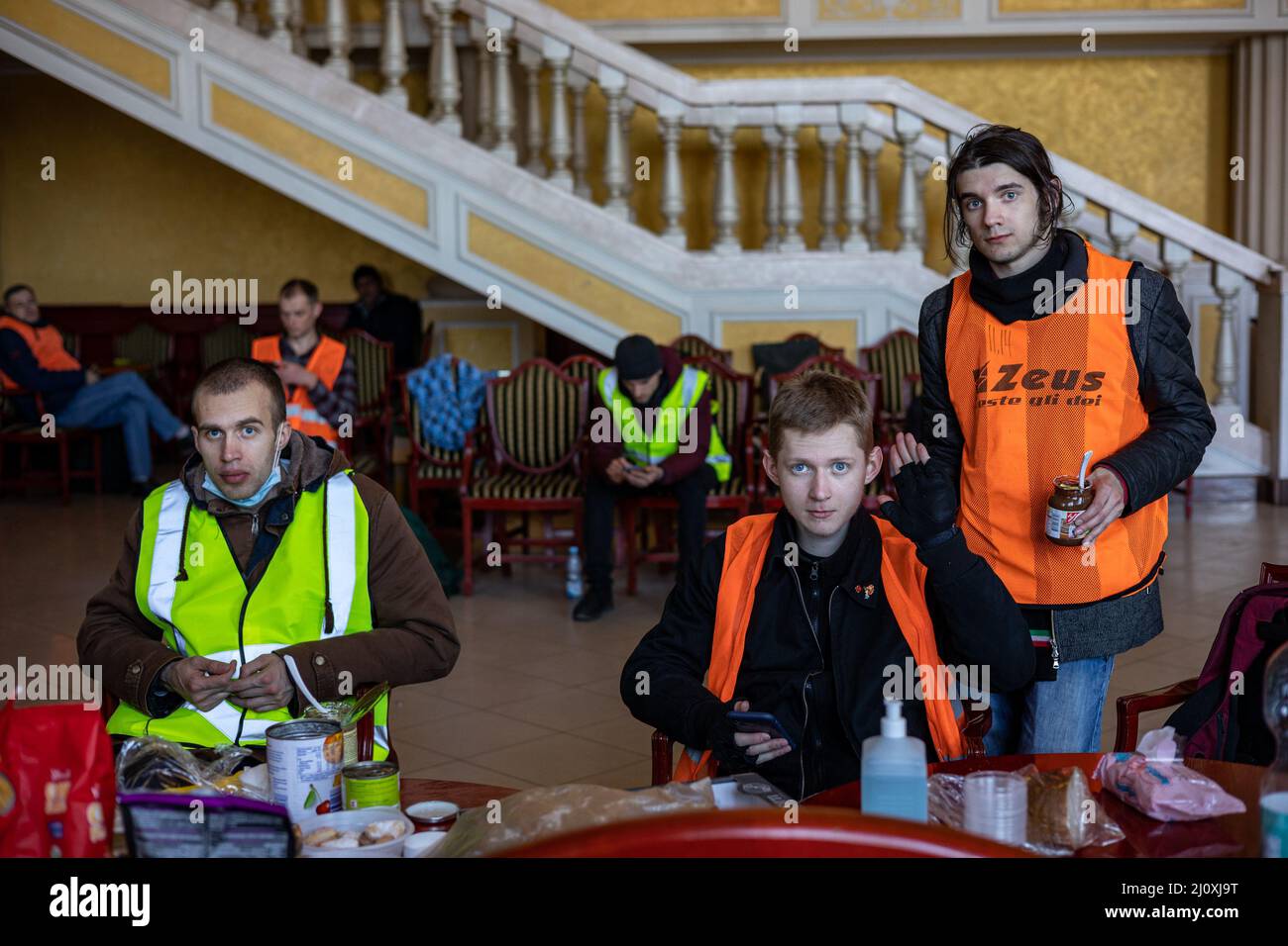 LVIV, UKRAINE -March 14, 2022: Humanitarian crisis during the war in Ukraine. Volunteers have a rest in the volunteer center at Lviv Railway Station. Stock Photo