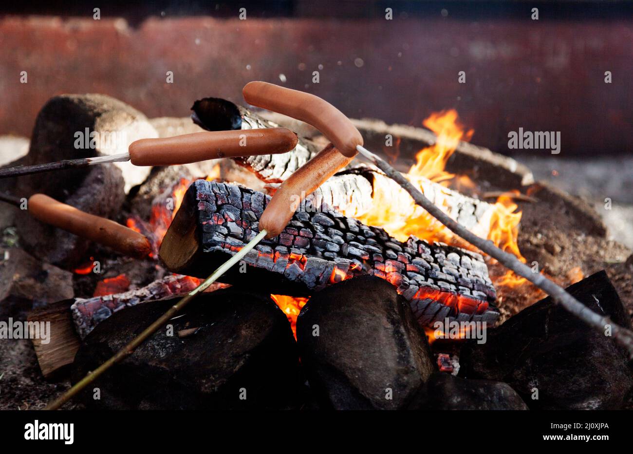 grill sausages over an open fire outdoors Stock Photo