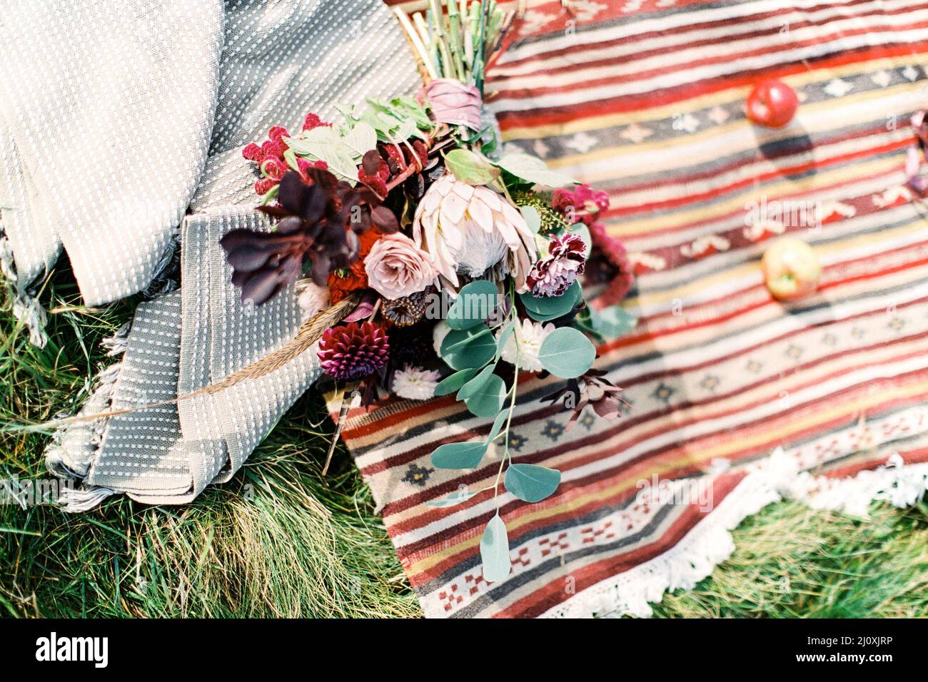 Wedding bouquet lies on a homespun bedspread Stock Photo