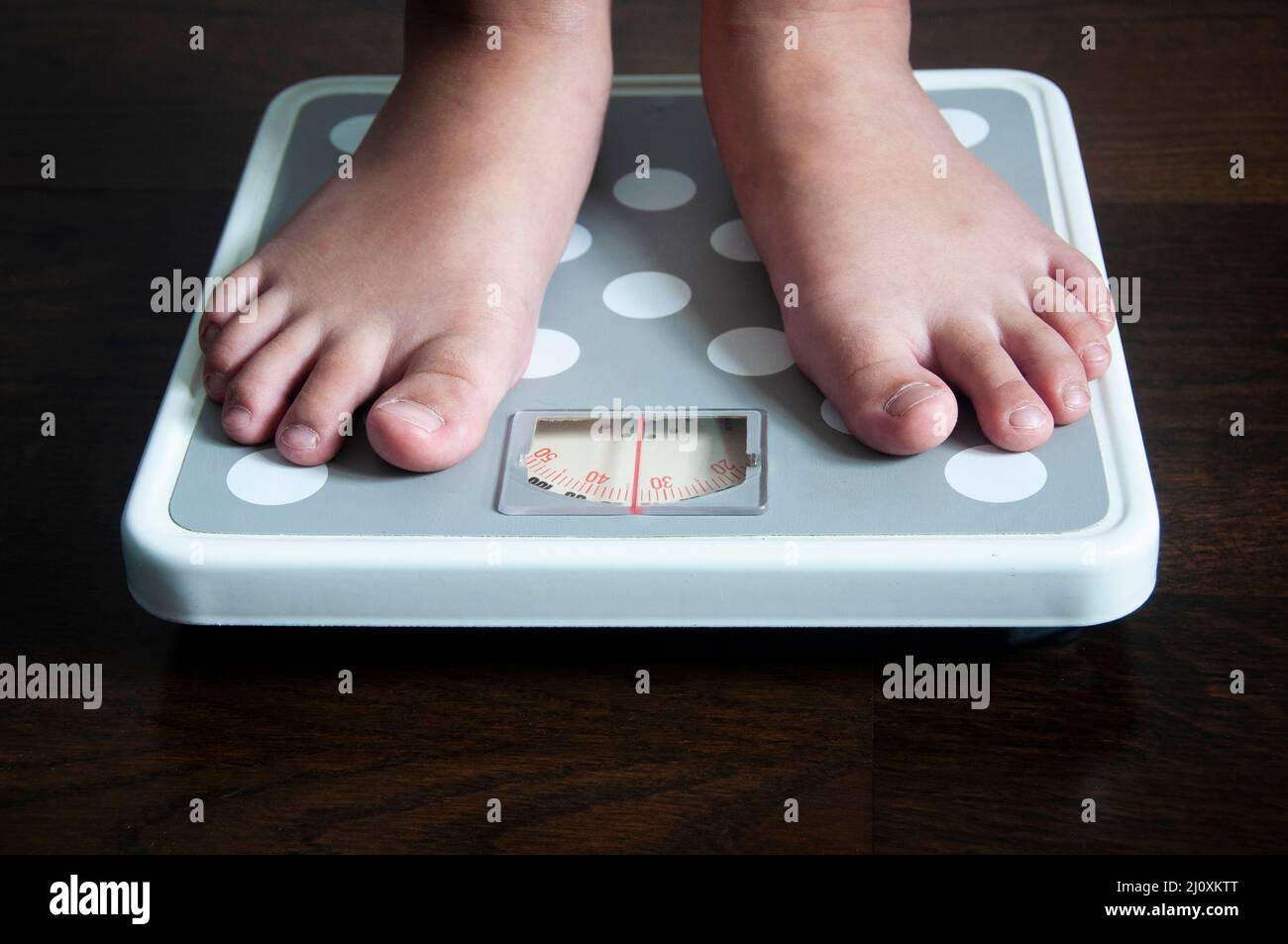 Straight view of feet on weight scale . Weight loss and fitness concept. Stock Photo