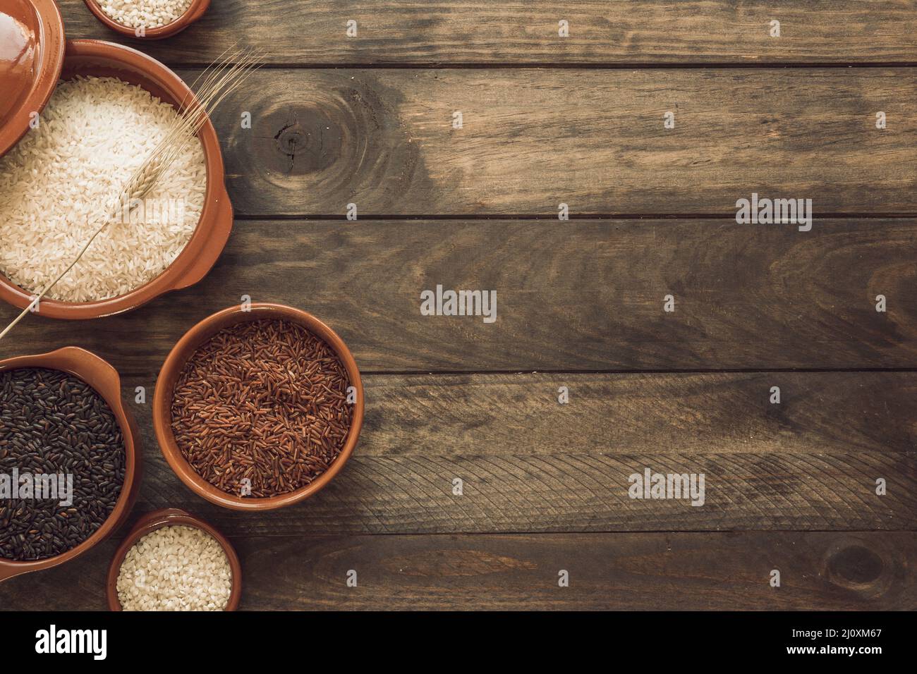 Overhead view red brown white rice bowls wooden background. High quality beautiful photo concept Stock Photo