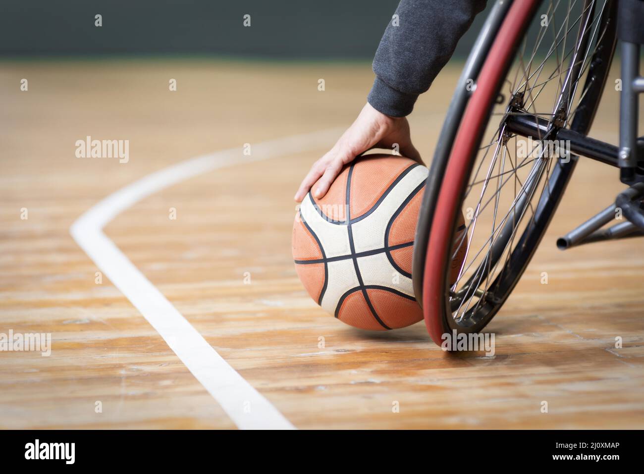 Close up hand holding basketball Stock Photo