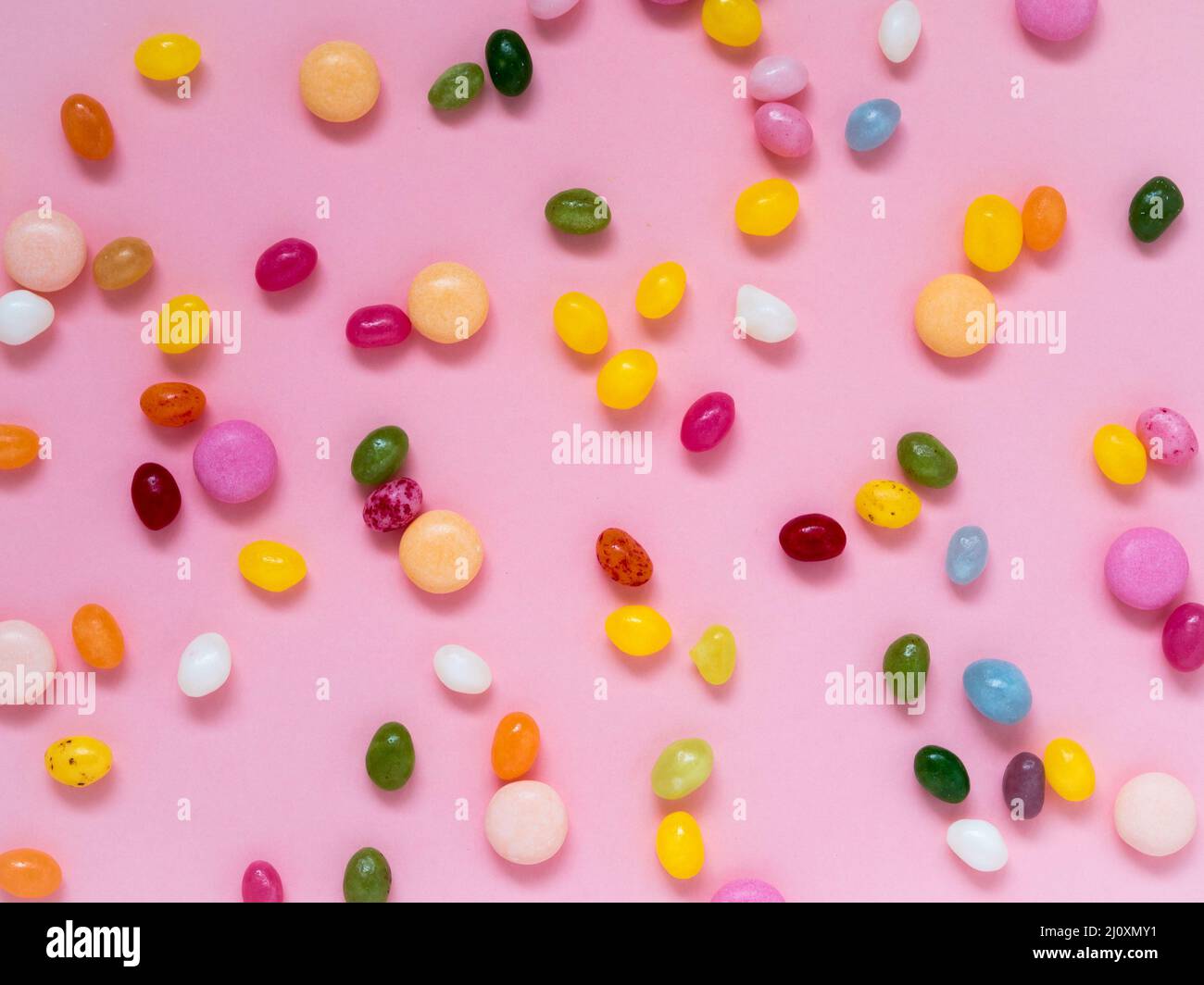 Many scattered colorful sweets, candies, lollipops Stock Photo