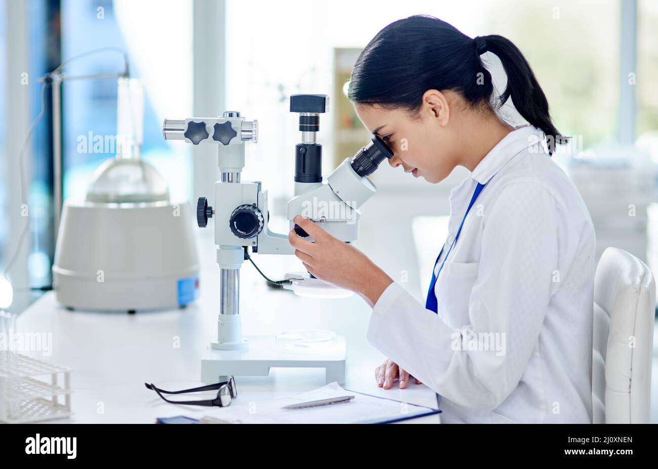 The closer she looks, the closer the answer. Shot of a young scientist