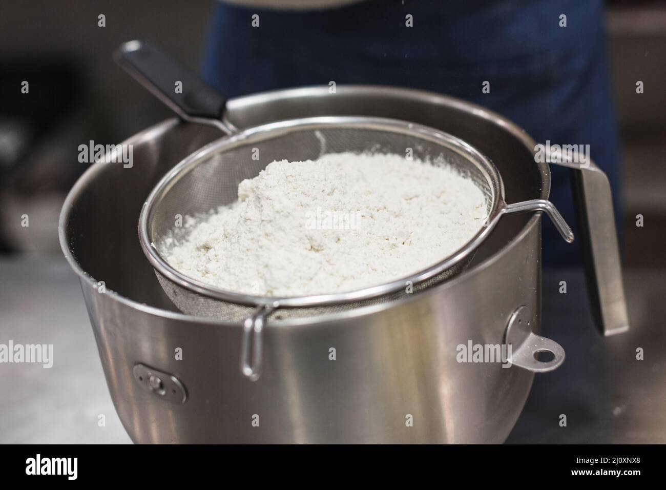 Flour inside sifter to pour into bowl Stock Photo Alamy