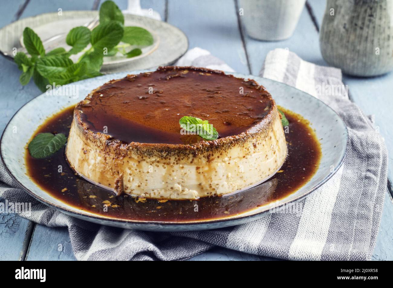 Traditionel French creme brulee served as top view on a design plate Stock Photo