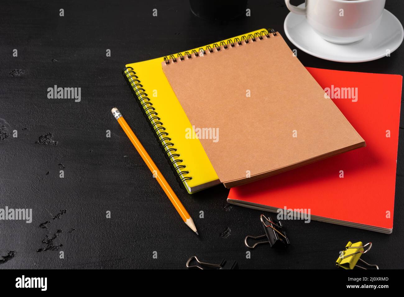 Three notepads on a black table close up Stock Photo