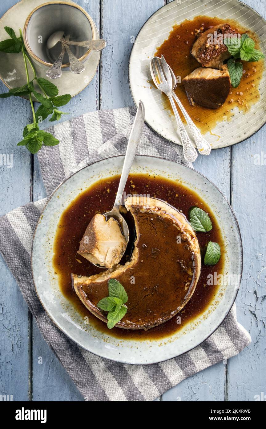 Traditionel French creme brulee served as top view on a design plate Stock Photo