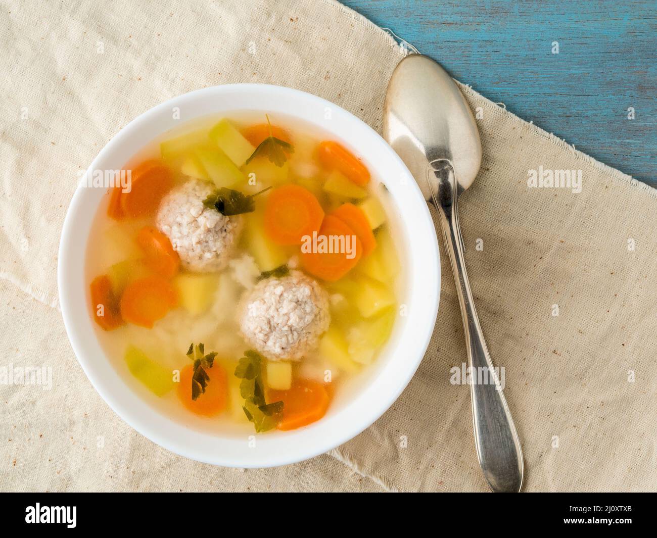 Bowl of soup, a cup of broth and vegetables, meatballs made of turkey