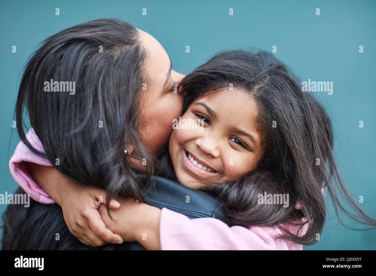 Little arms give the best hugs. Cropped portrait of a cute little girl hugging her mother. Stock Photo