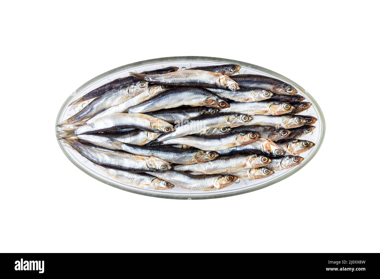 Salted fish european anchovy on an oval glass plate  isolated on a white background close-up top view Stock Photo