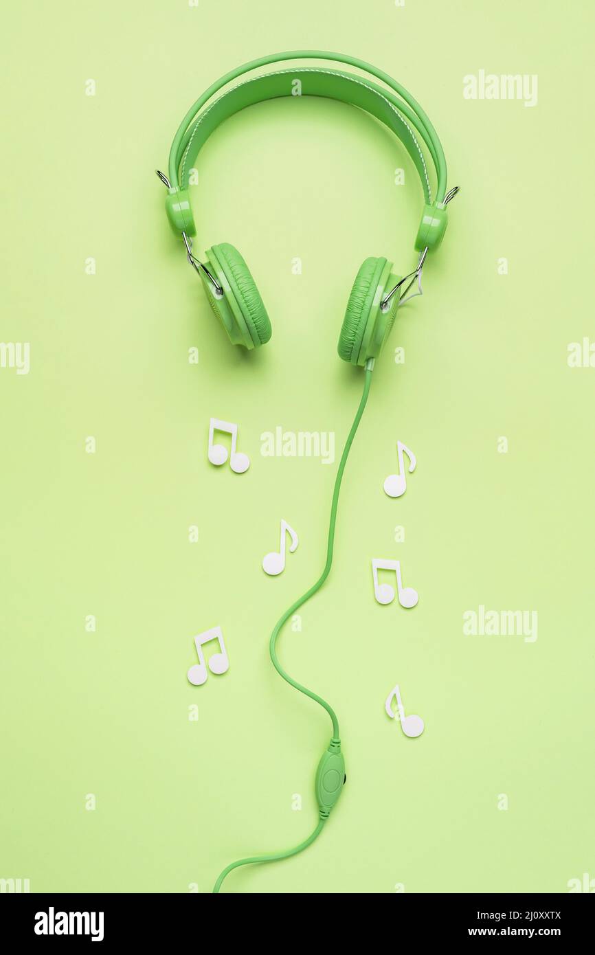 Green headphones with white musical notes. High quality photo Stock Photo