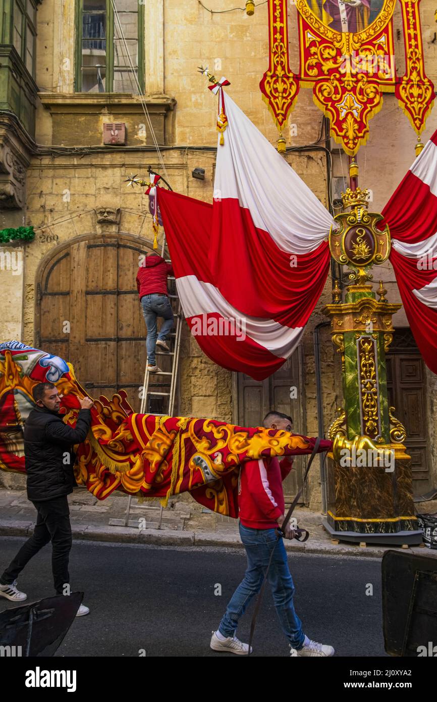 Putting up banners in the streets ready for the Feast of Saint Paul's Shipwreck, Valletta, Malta Stock Photo