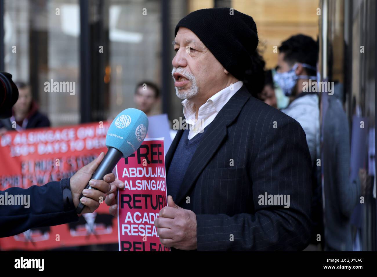 A Bahraini activist conducts a media interview during a protest outside Formula 1’s offices in London, UK on March 18, 2022, ahead of the grand prix in Bahrain Stock Photo