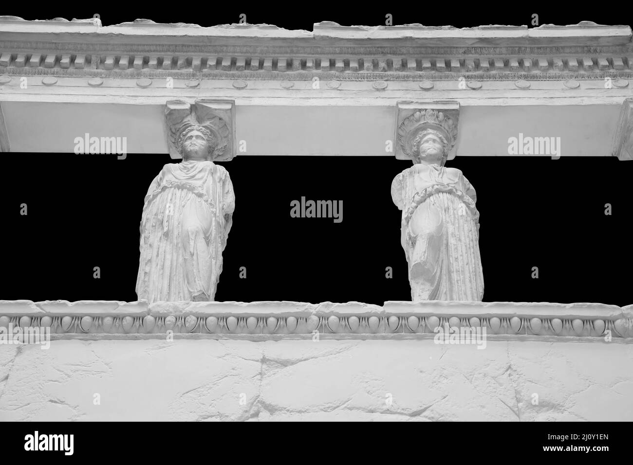 The Caryatid porch of the Erechtheion Temple in Athens isolated on black background with clipping path Stock Photo