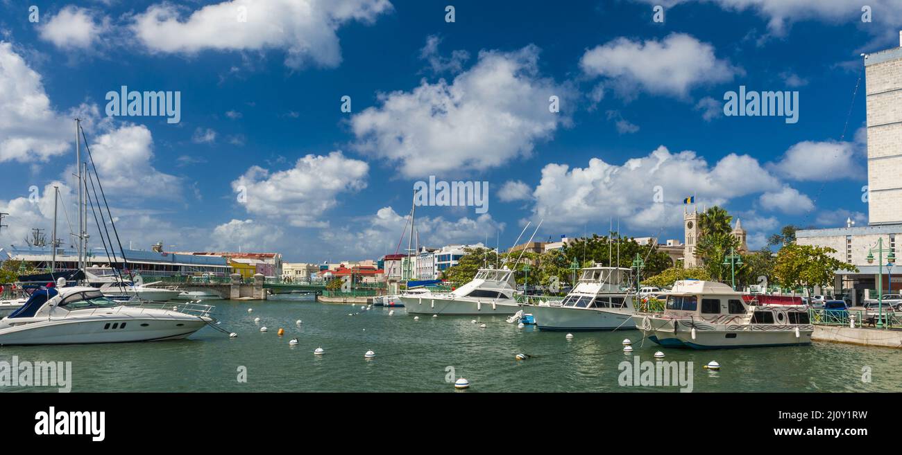 Main water canal with ships and shops in Bridgetown, capital of Barbados. Caribbean Stock Photo
