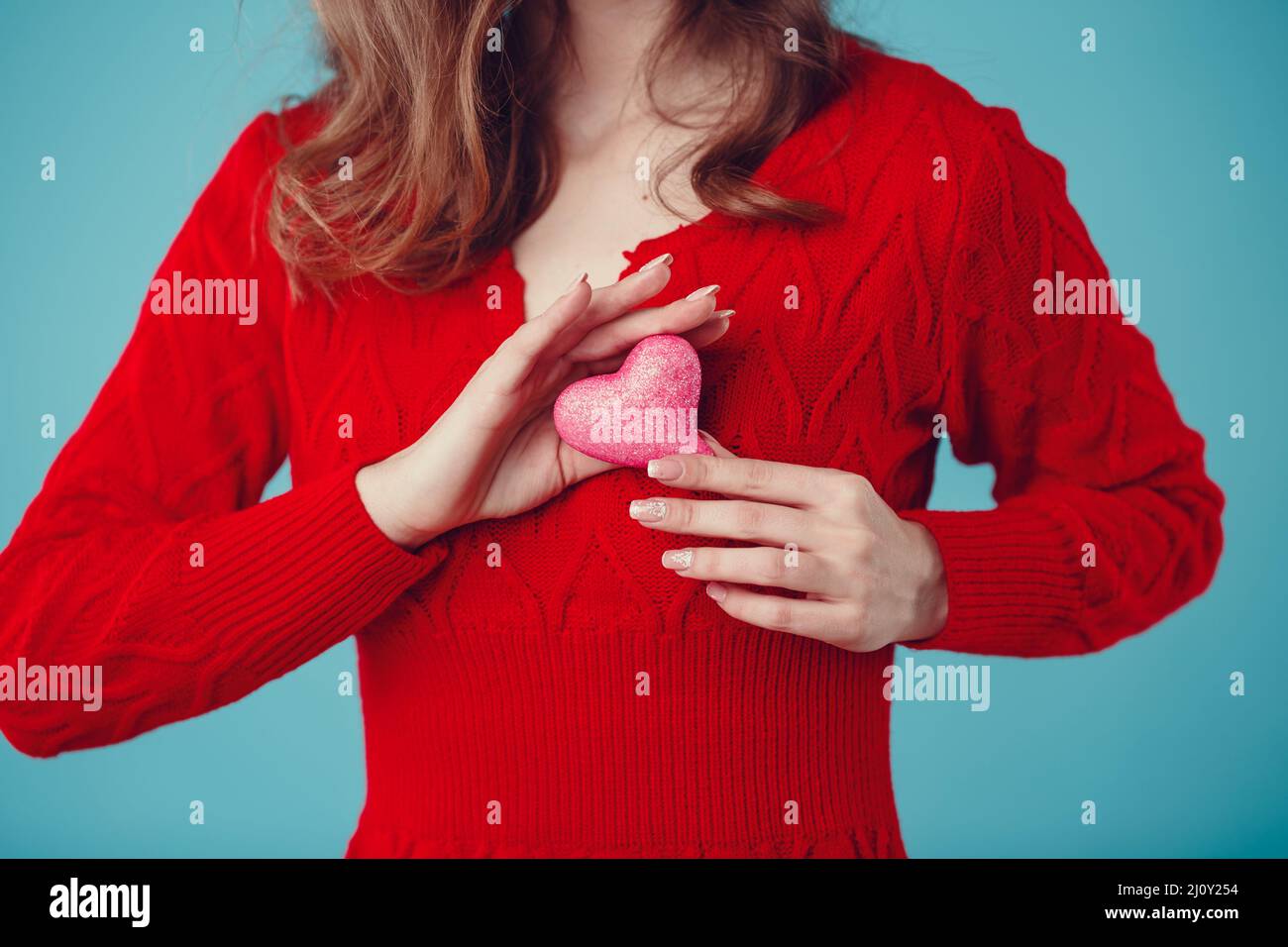 Beautiful little heart covered with sparkles in the hands of a