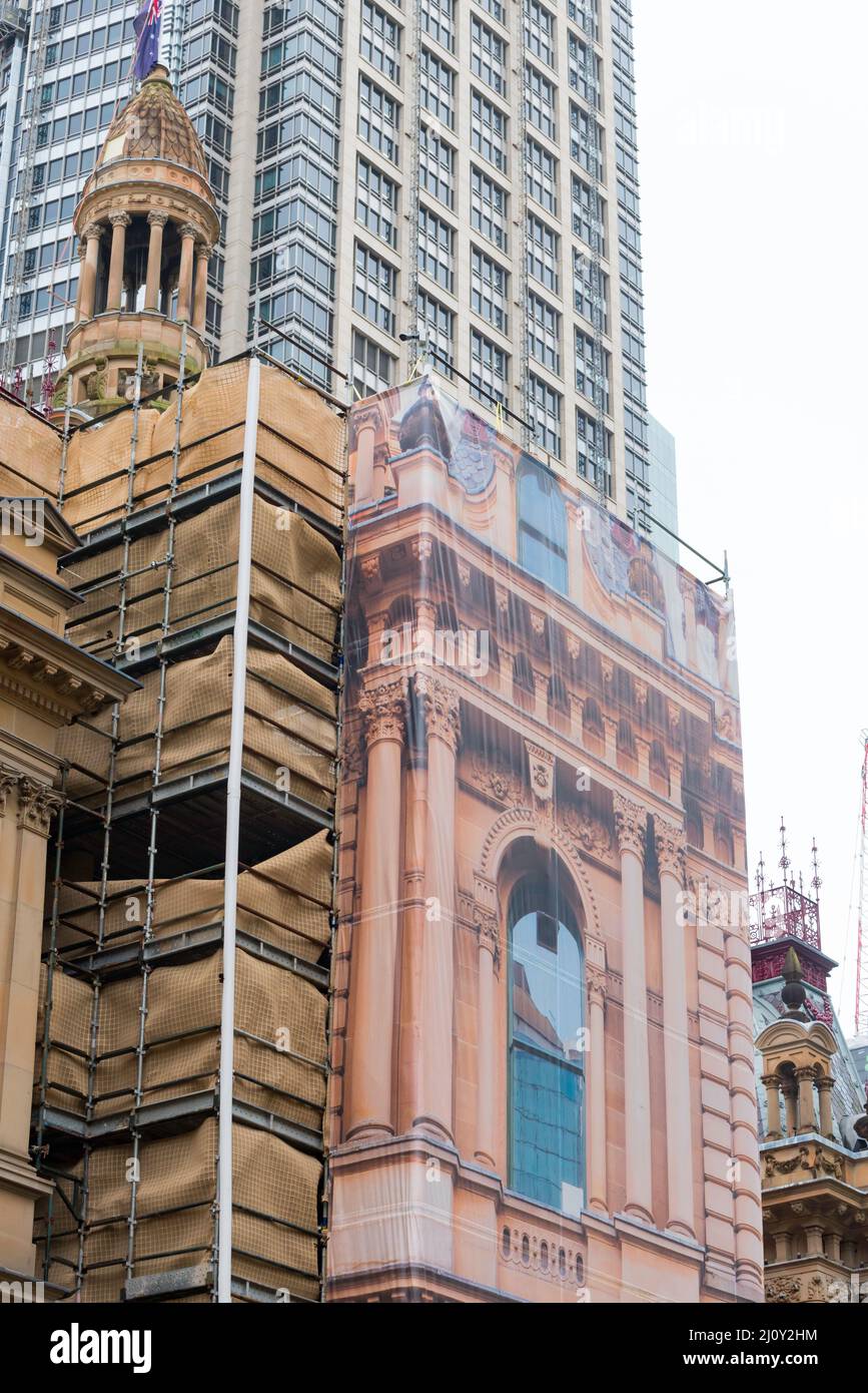 Scaffolding mesh screens covering the Sydney Town Hall are printed with details of the building they cover during restoration work on the building Stock Photo