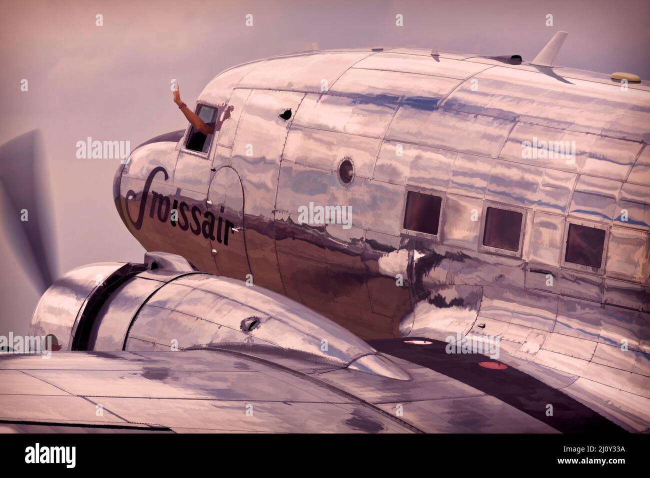 Douglas DC-3 Dakota, the pilot waving as they set of to depart. Stock Photo