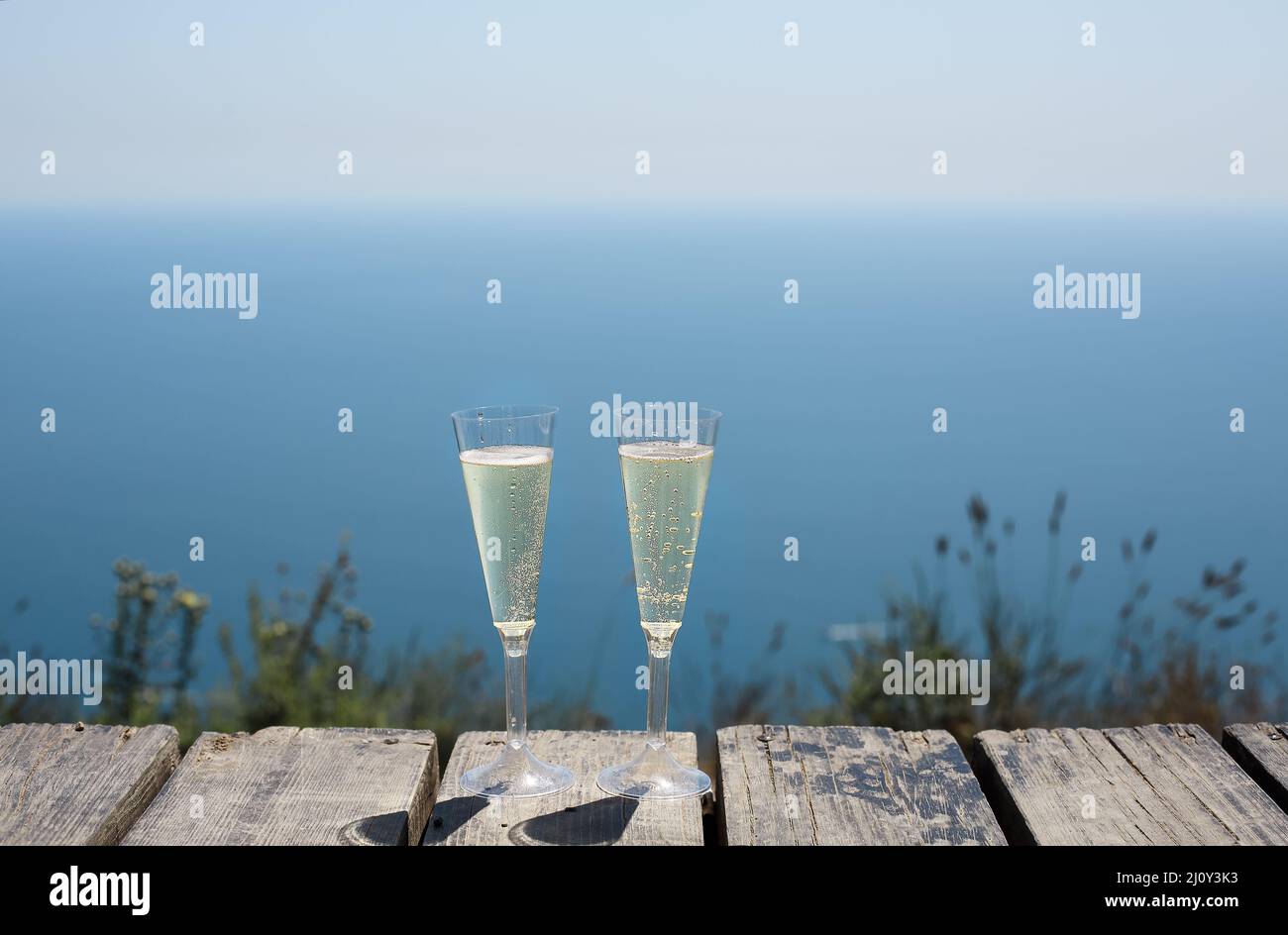 Champagne glasses by the blue sea Stock Photo