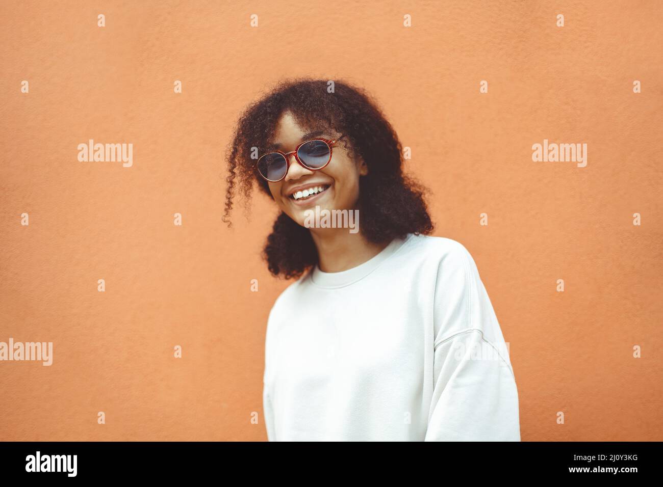 African ethnicity young woman in stylish sunglasses Stock Photo