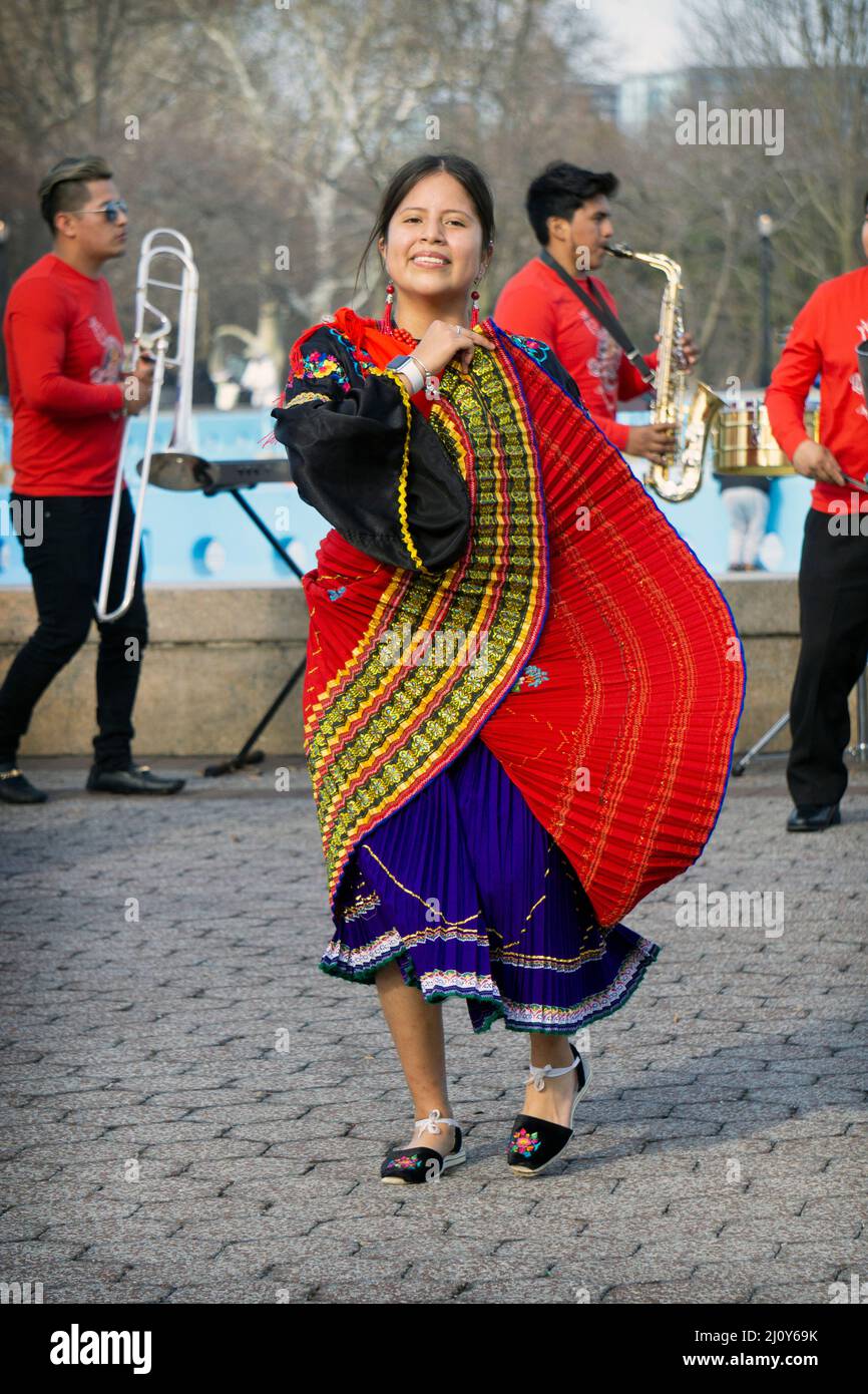 A teenage member of Jatary Muzhucuna, an Ecuadorian American music & dance troupe, performs near the a park in Queens, New York City. Stock Photo