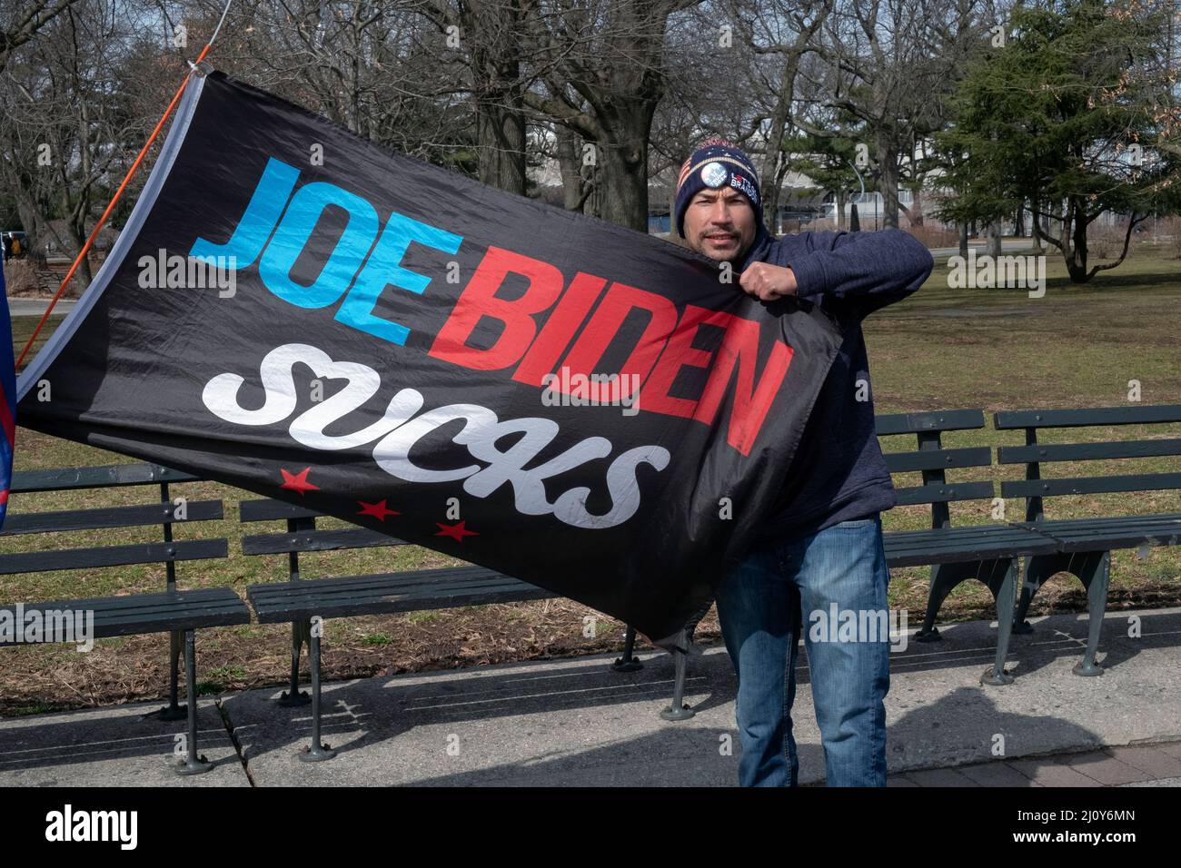 Dominican American right wing Trump supporter who rides around on his bike with pro Trump and anti Biden banners. In a park in Queens, New York City. Stock Photo
