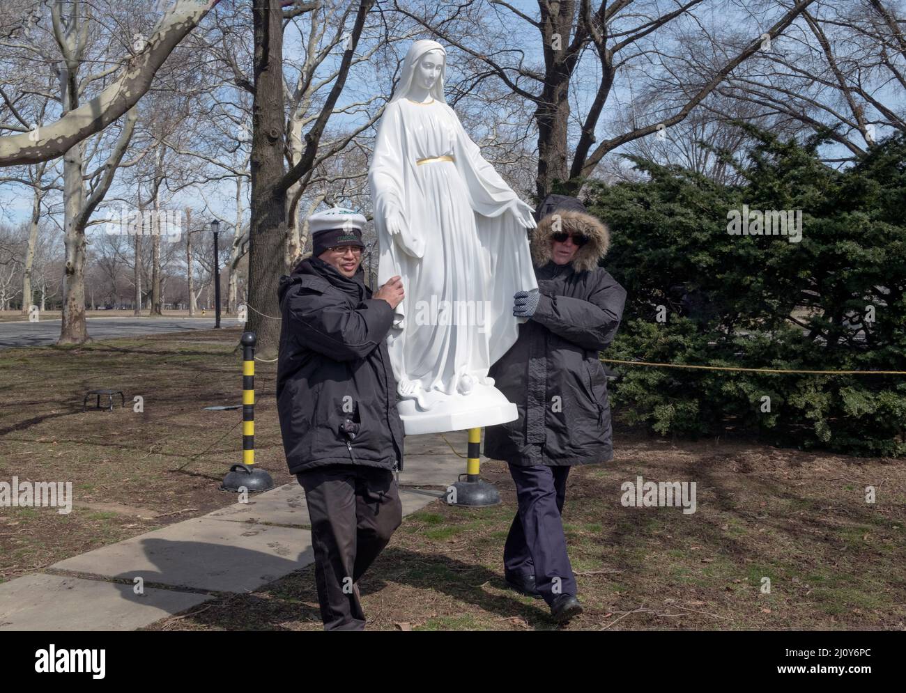 After a prayer service devout Roman Catholics move a statue of the