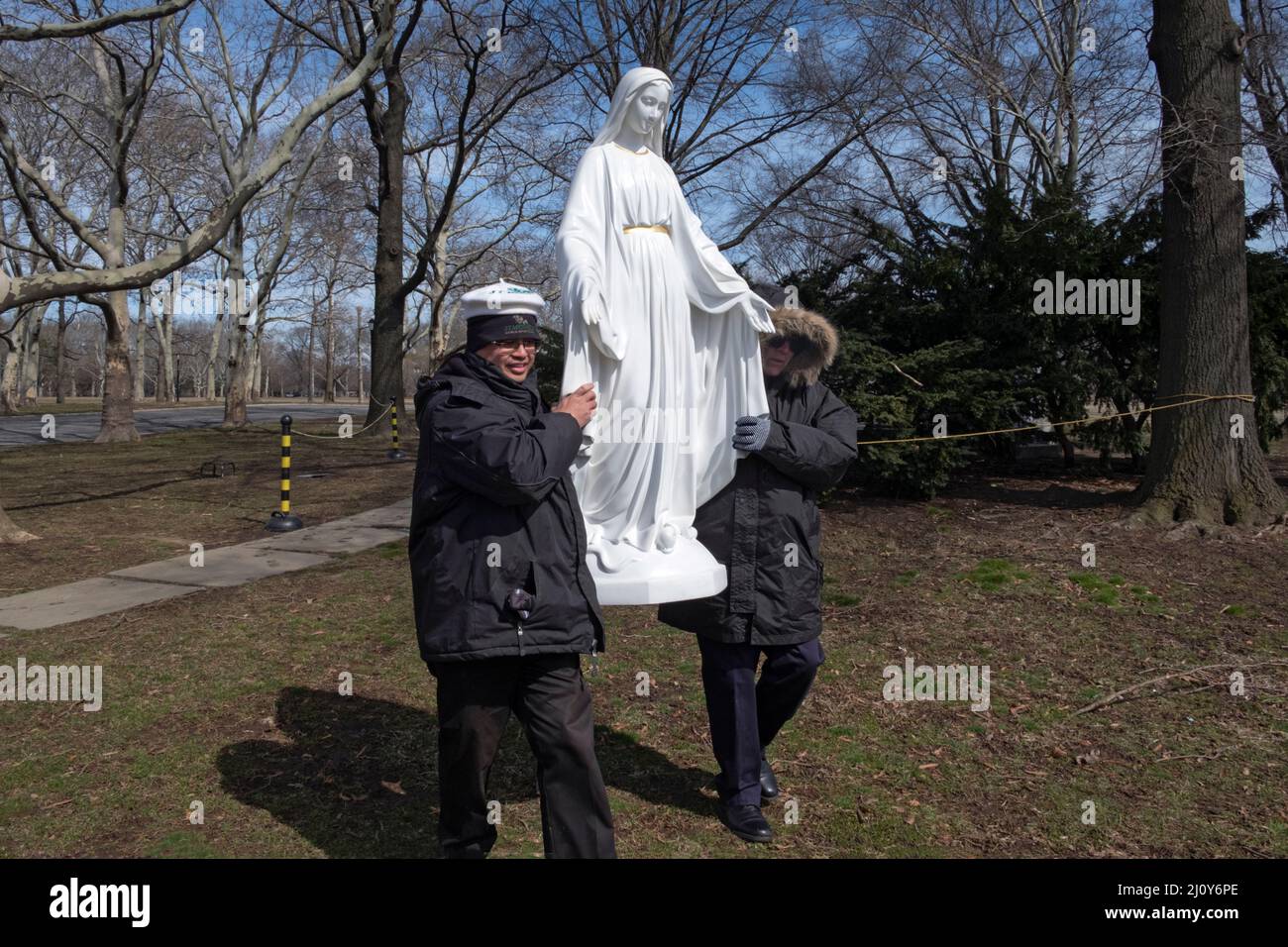After a prayer service devout Roman Catholics move a statue of the
