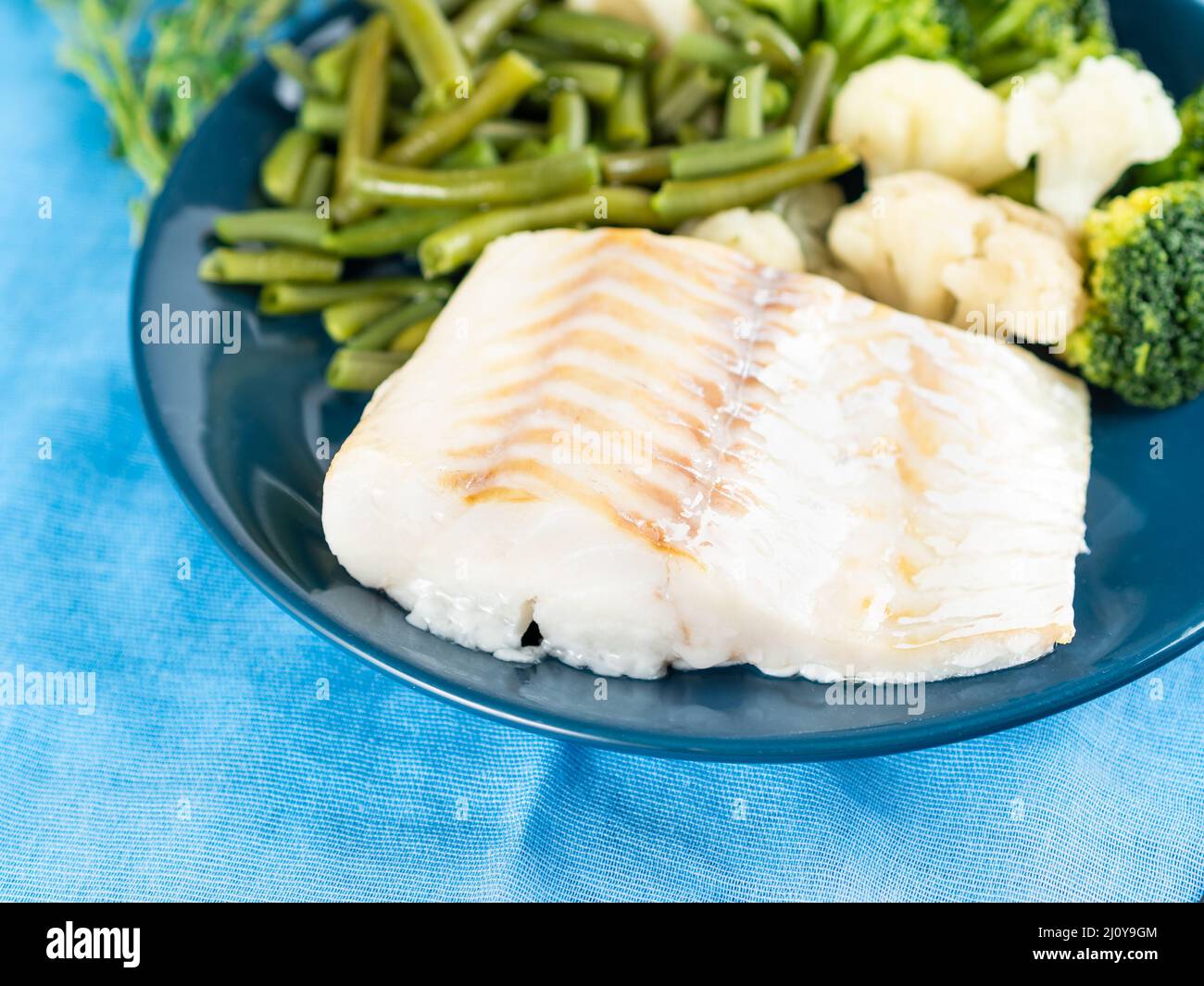 Fillet of boiled sea fish cod with broccoli, green beans and ...