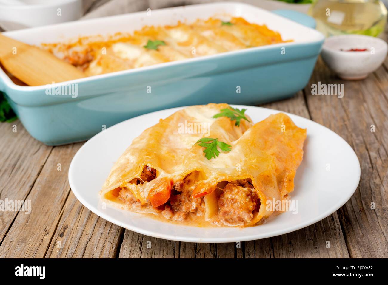 Cannelloni with filling of ground beef, tomatoes, baked with bechamel