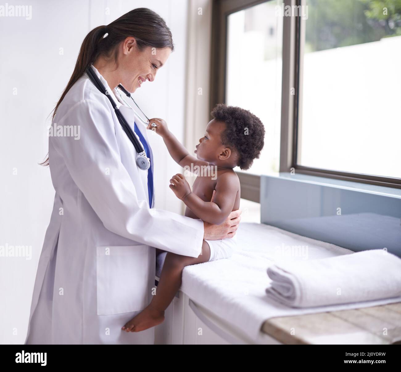 Just in for a routine pediatric checkup. Cropped shot of a female pediatrician doing a checkup on an adorable baby boy. Stock Photo
