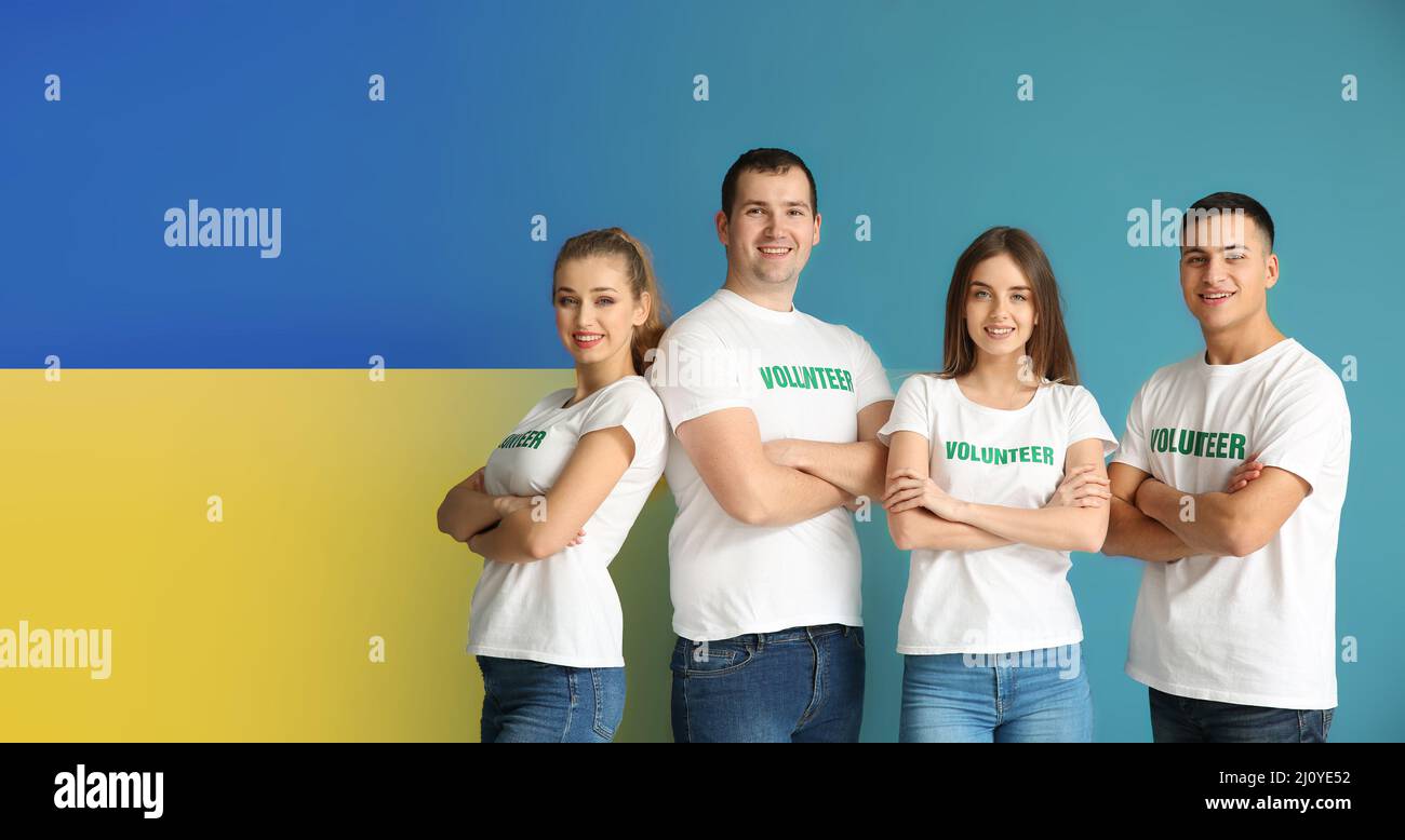 Team of volunteers on color background. Humanitarian assistance for Ukraine Stock Photo