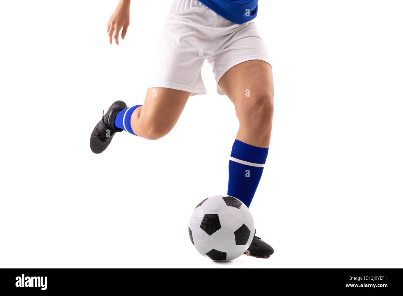 Low Section Of Biracial Young Female Soccer Player Kicking Soccer Ball Against White Background 9243