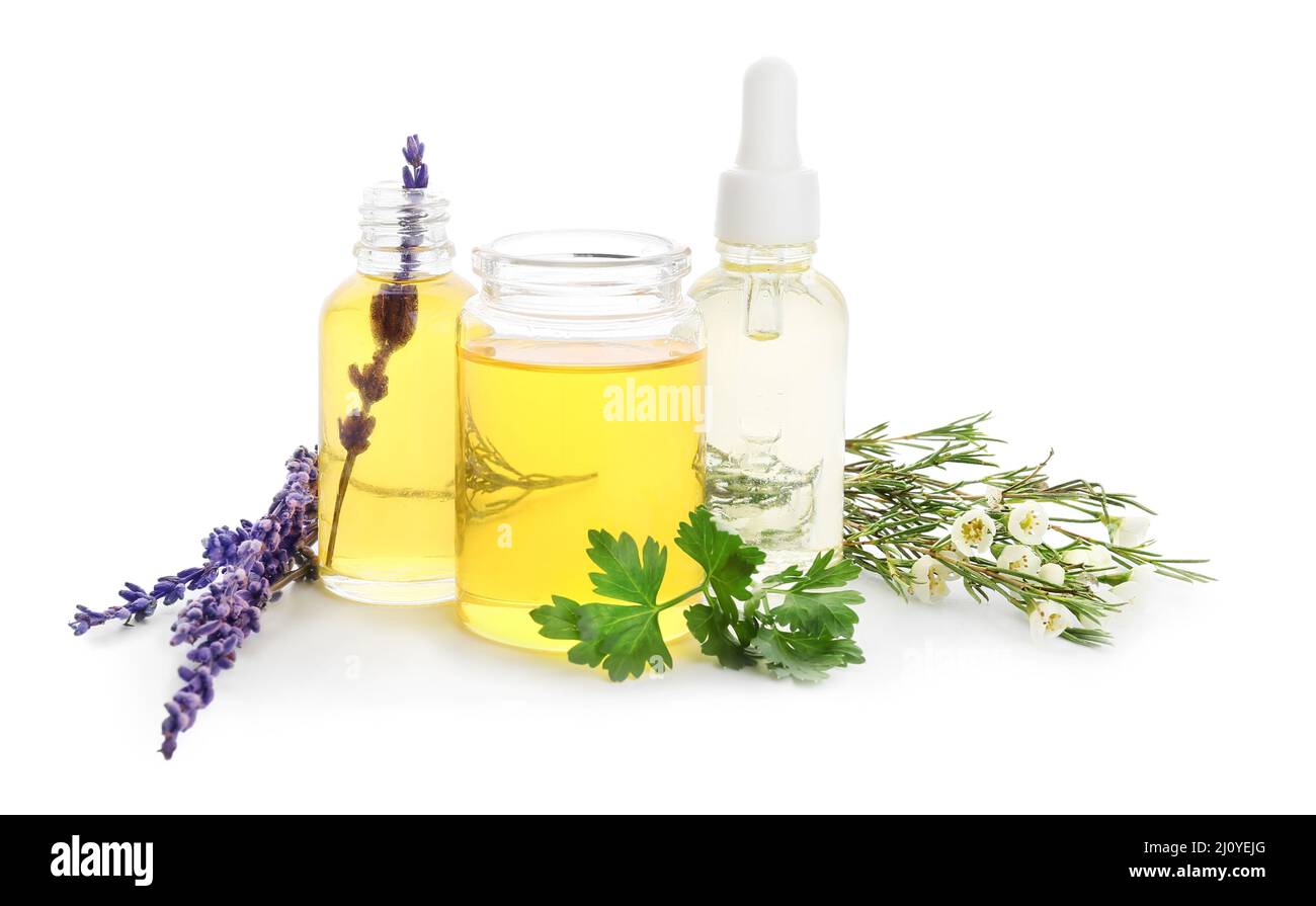 Bottles of natural essential oils on white background Stock Photo - Alamy