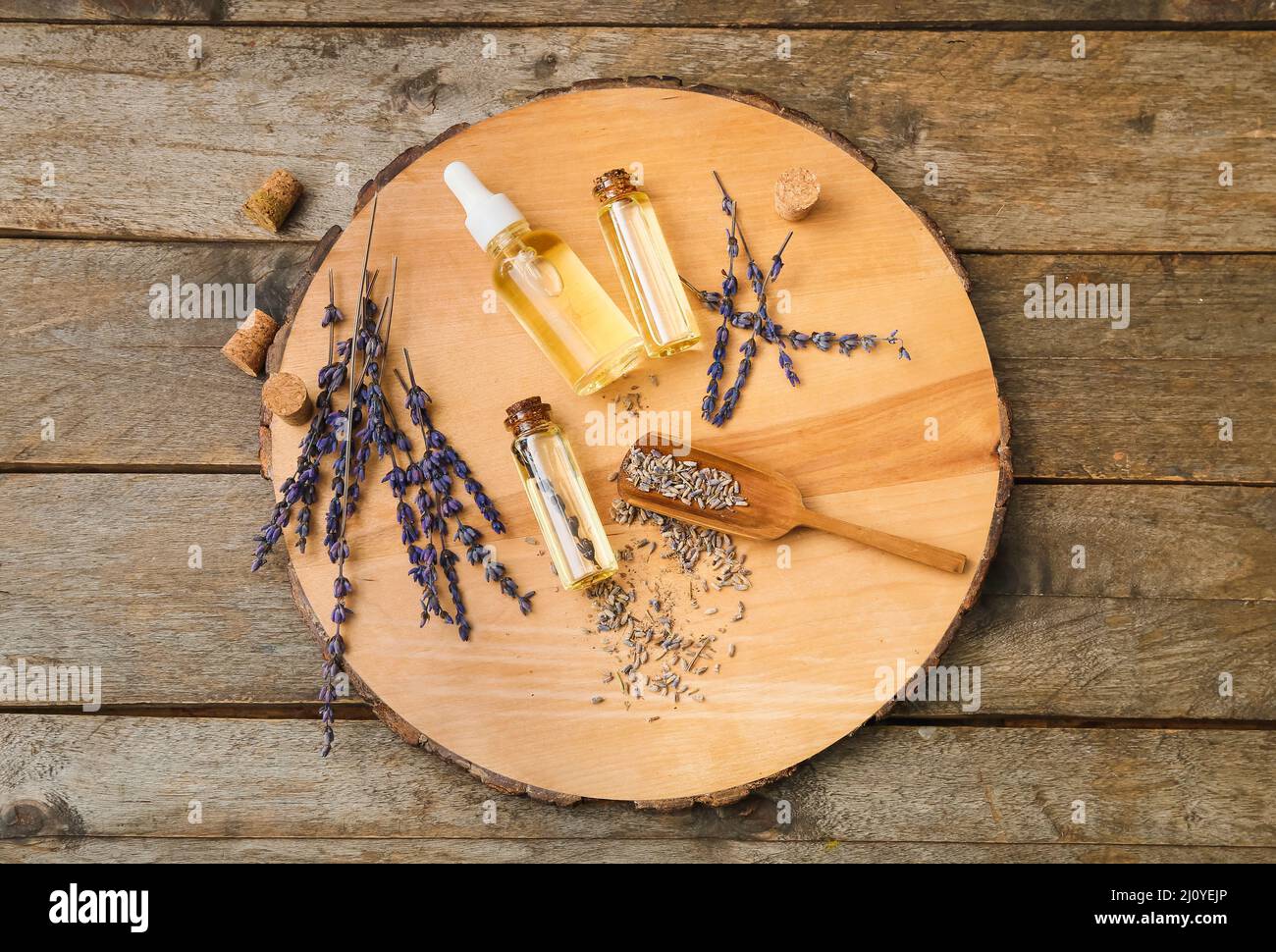 Bottles of natural lavender essential oil on wooden background Stock ...