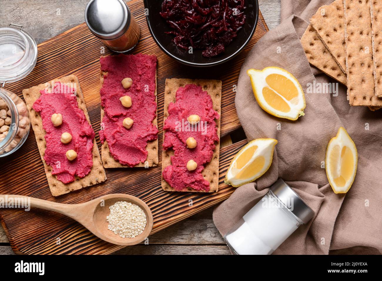 Crispbreads with tasty beetroot hummus on table Stock Photo