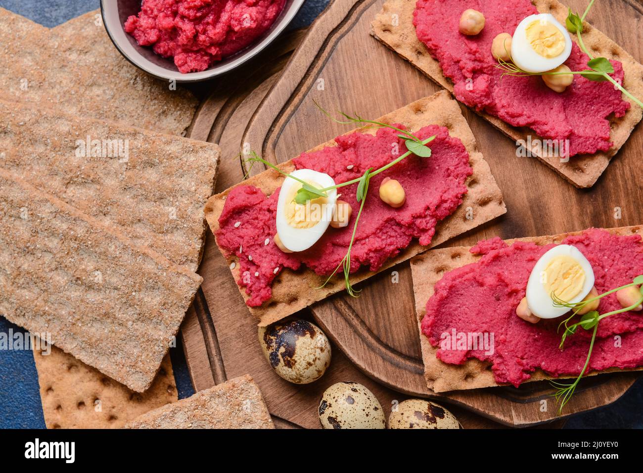 Crispbreads with tasty hummus on table Stock Photo