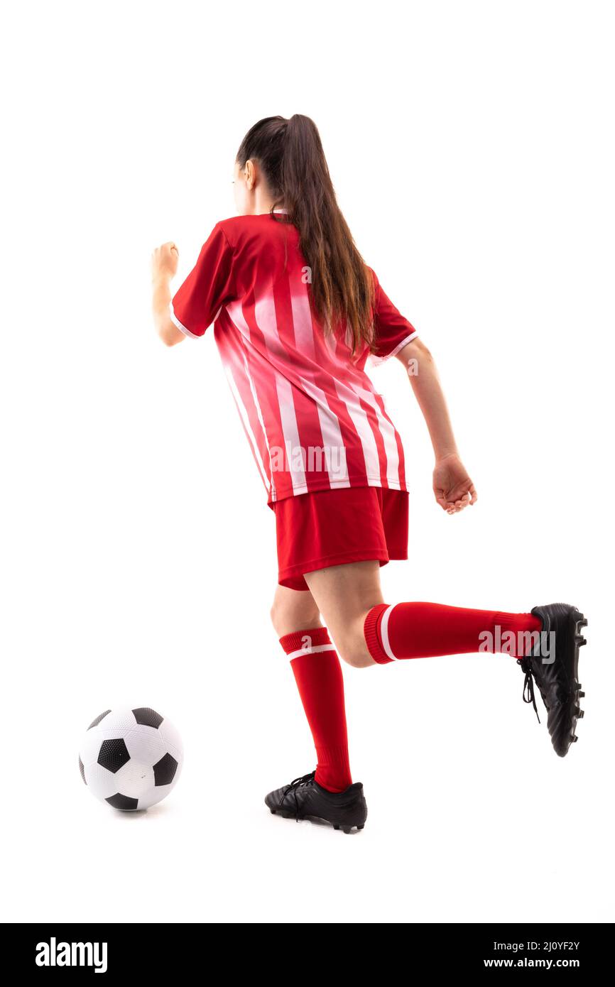 Full length of caucasian young female soccer player playing soccer