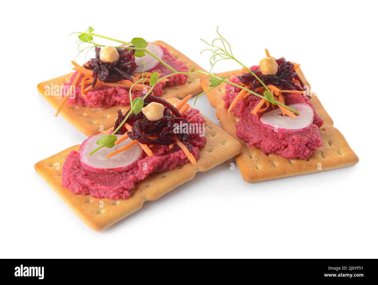 Crispbreads with tasty beetroot hummus on white background Stock Photo