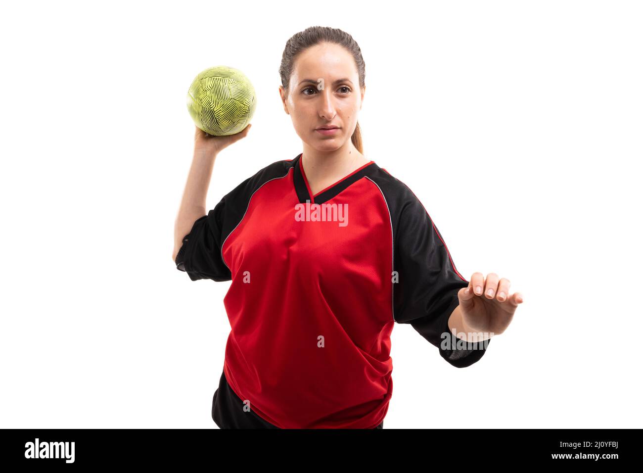 Caucasian young female sports player throwing handball while standing