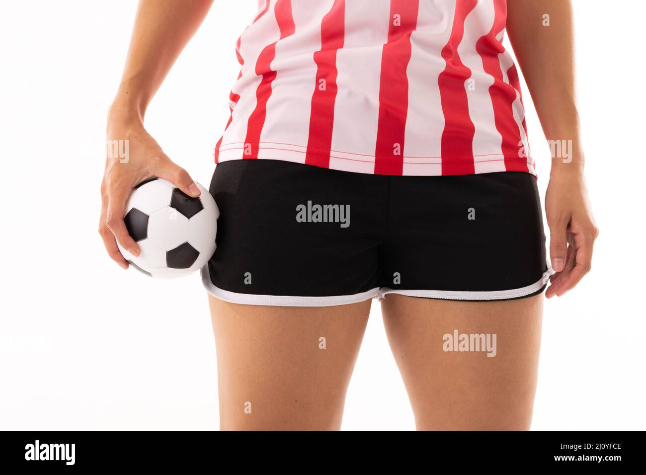 Midsection of biracial young female player holding handball ball ...