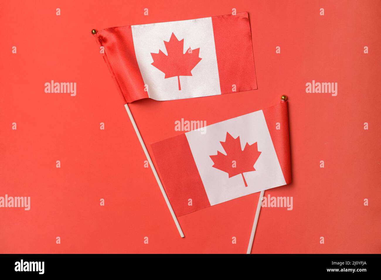 Canadian flags on red background Stock Photo Alamy