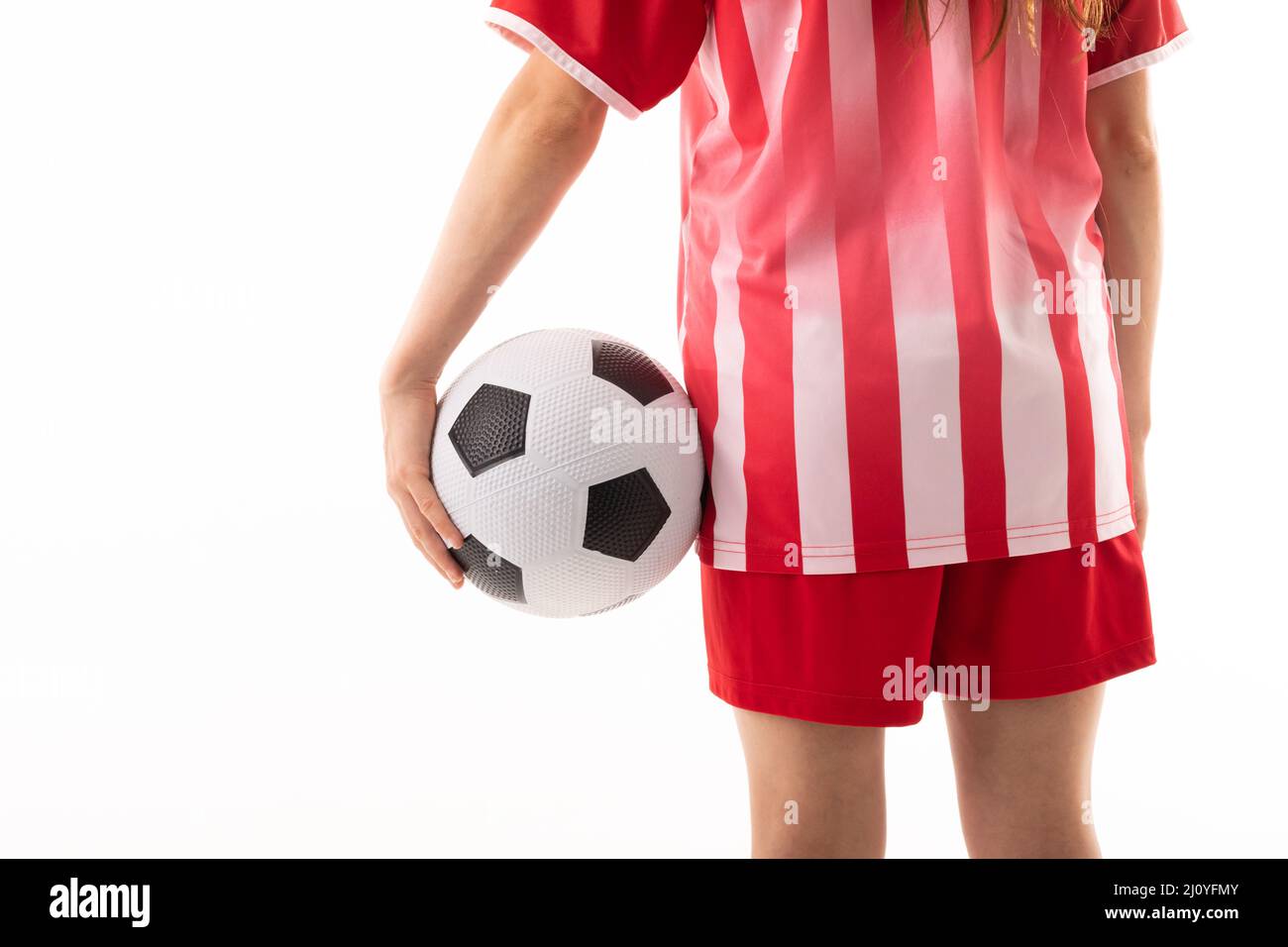 Midsection of caucasian young female soccer player with soccer ball ...