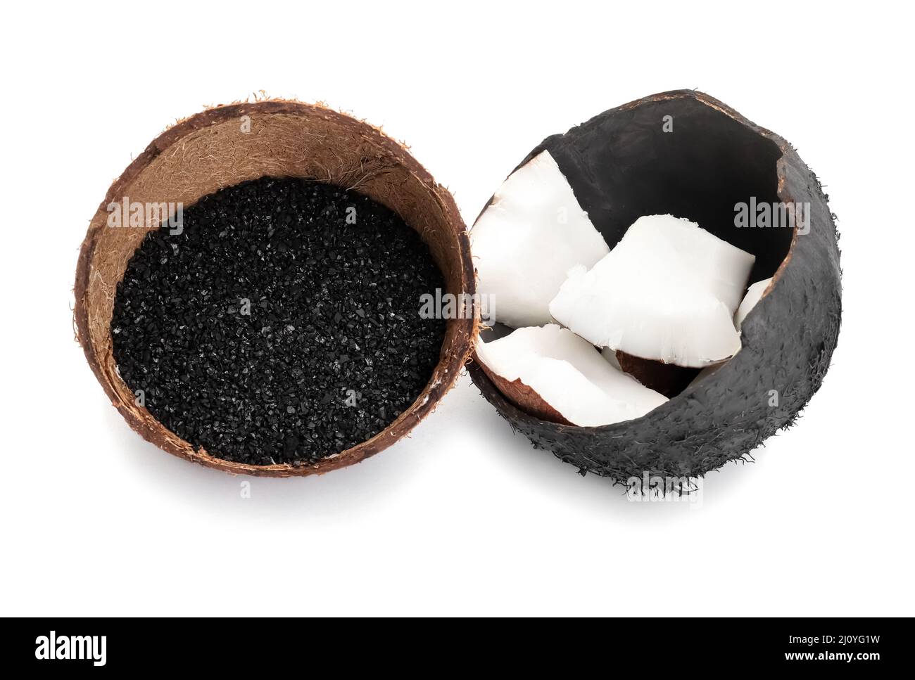 Coconut shells with activated carbon on white background Stock Photo