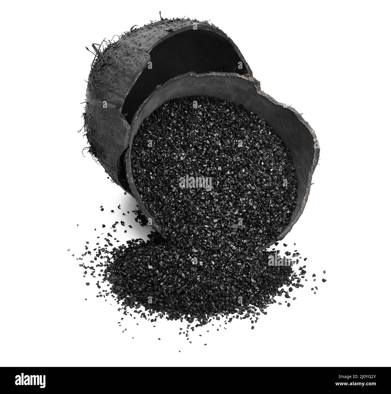 Coconut shells with activated carbon on white background Stock Photo