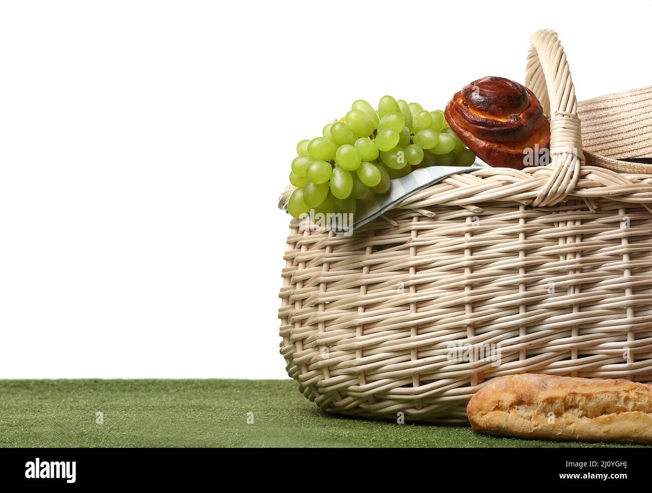 Wicker basket with tasty food for picnic on white background Stock ...